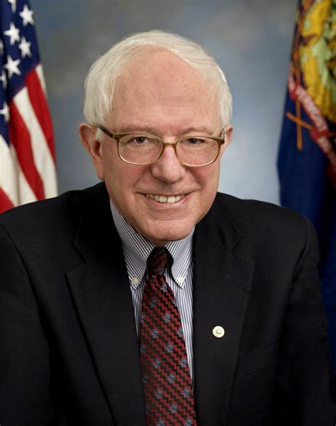 Bernie Sanders sitting with his arms crossed