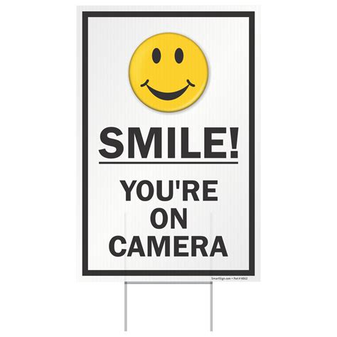 Displaying Your Free Smile You're On Camera Sign