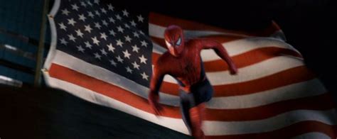 Spiderman standing in front of the American flag