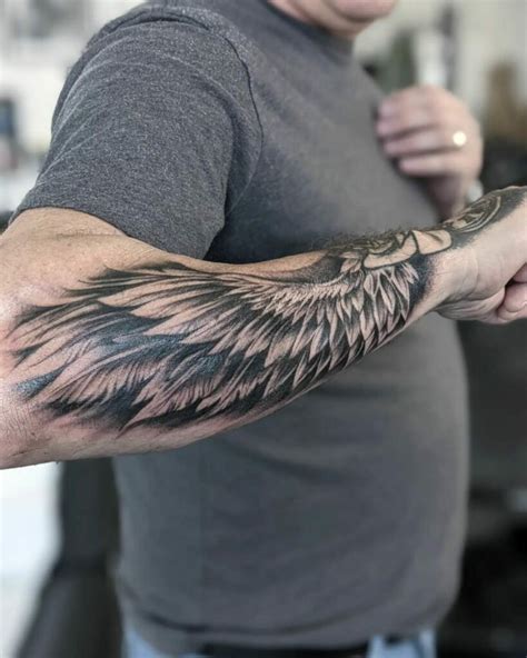 Feathered wings tattoo